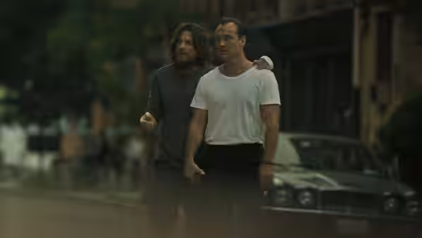 Vince Friedken (Jason Bateman) walking with Jake Friedken (Jude Law) on a wet street
