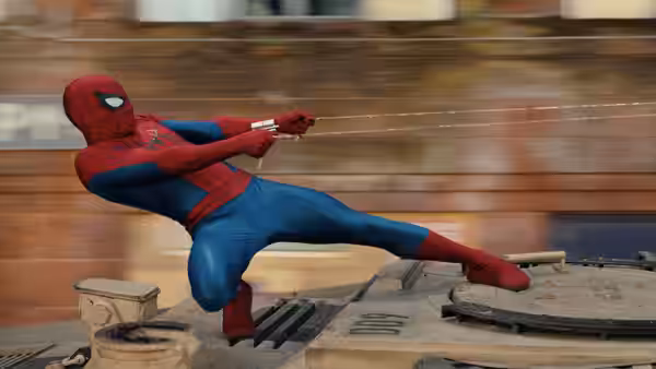Spider-Man (Tom Holland) balances on a vehicle while pulling a web line in a city