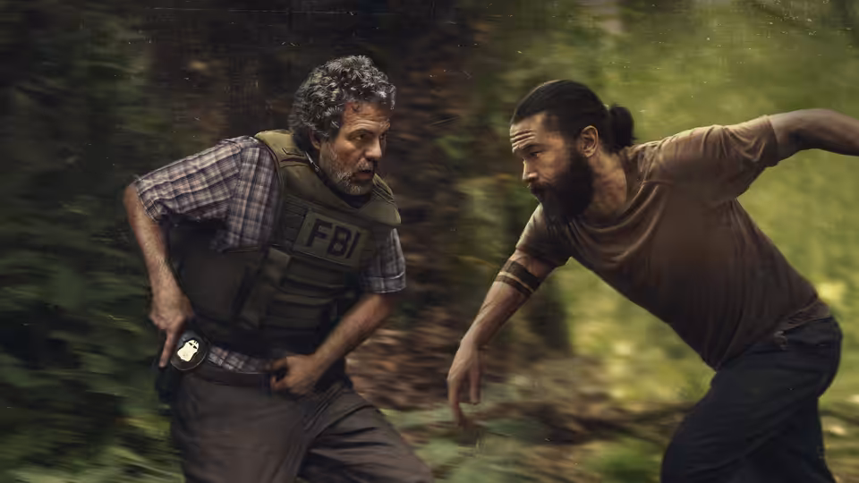 Tom Brandis (Mark Ruffalo) and Robbie Prendergrast (Tom Pelphrey) running through a forest