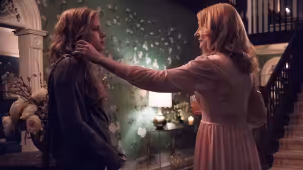 Adora Crellin (Patricia Clarkson) touching Camille Preaker (Amy Adams) indoors