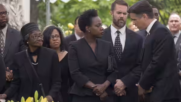 Viola Davis as Veronica Rawlings clasping hands with a man at a funeral