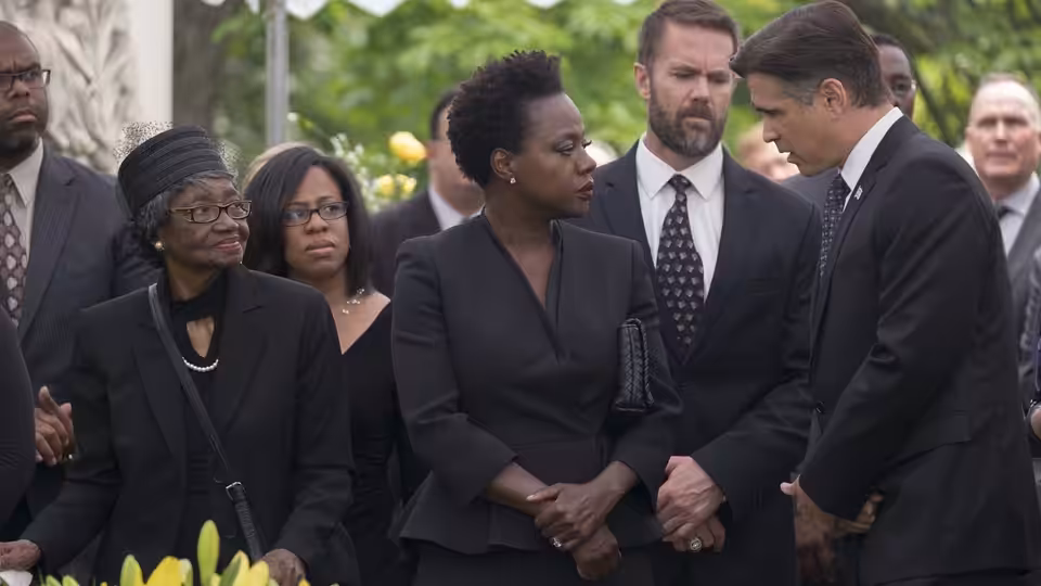 Viola Davis as Veronica Rawlings clasping hands with a man at a funeral