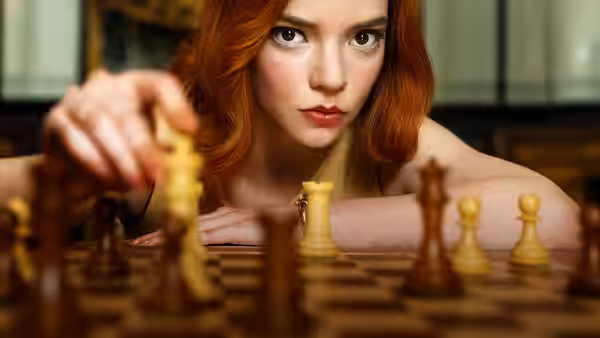Beth Harmon (Anya Taylor-Joy) moving a white chess piece forward