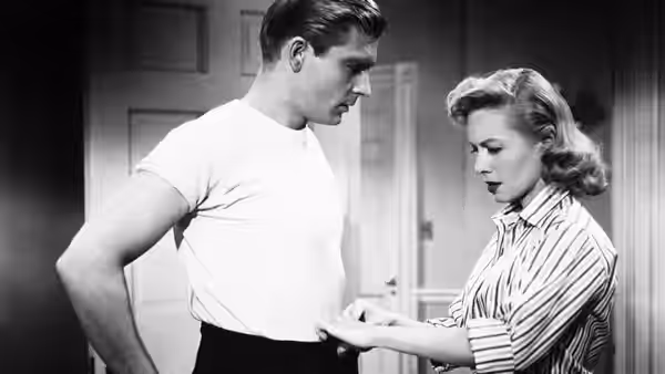 Louise Carey (Randy Stuart) measures Scott Carey’s waist as he looks down
