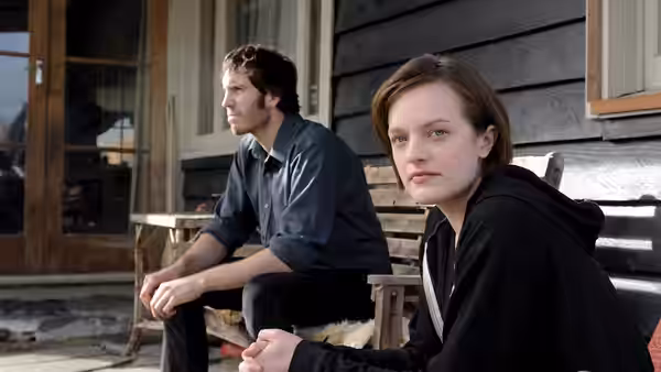 Robin Griffin (Elisabeth Moss) seated on porch with man beside her