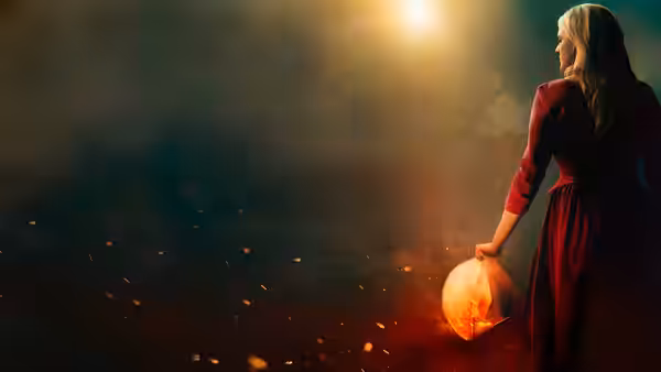 A woman in a red dress holding a glowing lantern amid sparks and smoke