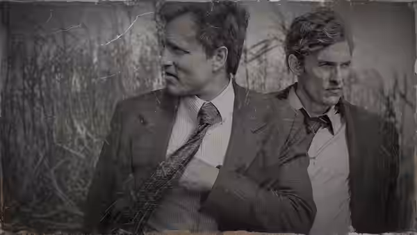 Rust Cohle (Matthew McConaughey) and Martin Hart (Woody Harrelson) in suits against a textured backdrop