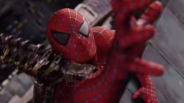 Spider-Man reaches out while a metal tentacle pins him against a building