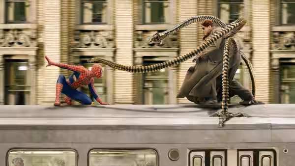 Spider-Man and Doc Ock battle atop a moving train as mechanical tentacles lash across the roof