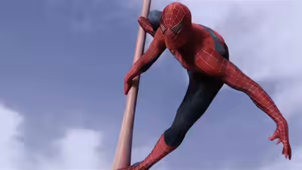 Spider-Man clings to a pole high above the city