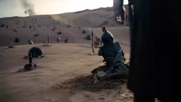 Fallen soldier in armor rests on a desert battlefield strewn with spears