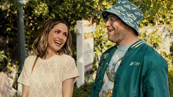 Sylvia (Rose Byrne) and Will (Seth Rogen) smiling together outdoors