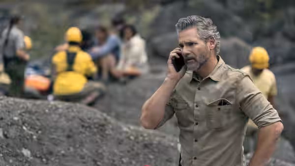 Kyle Turner (Eric Bana) speaking on a phone at a rocky rescue scene