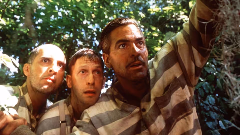 Everett (George Clooney) and two fellow convicts in the forest