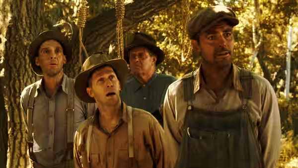 Four men standing beneath a tree with a dangling noose