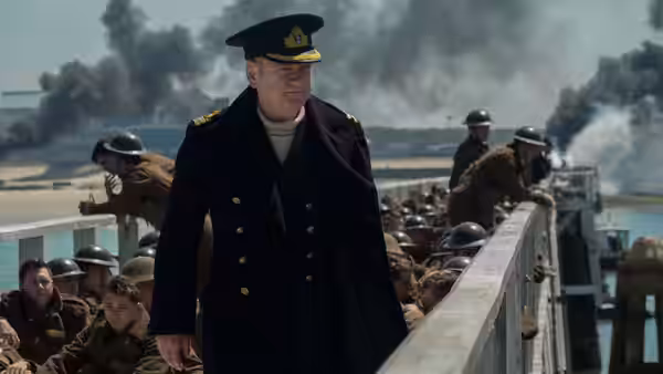 Commander Bolton (Kenneth Branagh) walking along a crowded pier