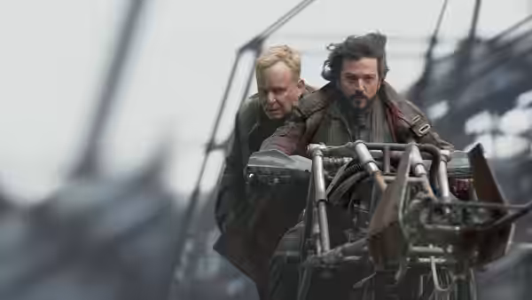 Cassian Andor (Diego Luna) gripping controls on a high metal platform