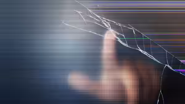finger touching a cracked screen with colorful horizontal lines