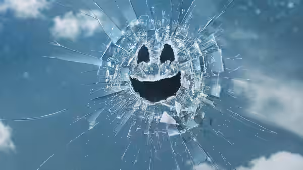 shattered glass forming a smiley face against a blue sky