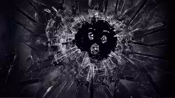 shattered glass with a dark circular void and faint reflections