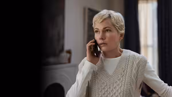 Molly Kochan (Michelle Williams) speaking on the phone indoors