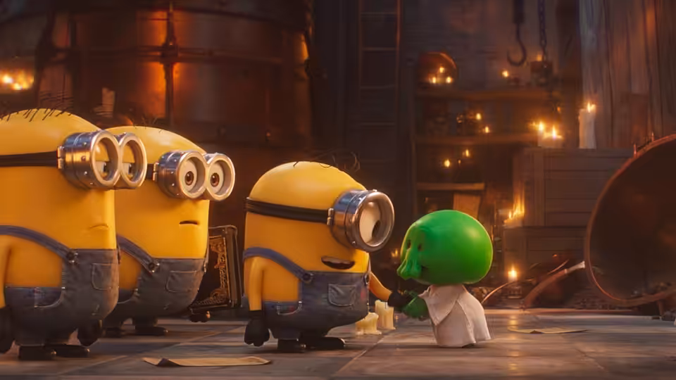 Three yellow minions facing a small green creature in an industrial hall