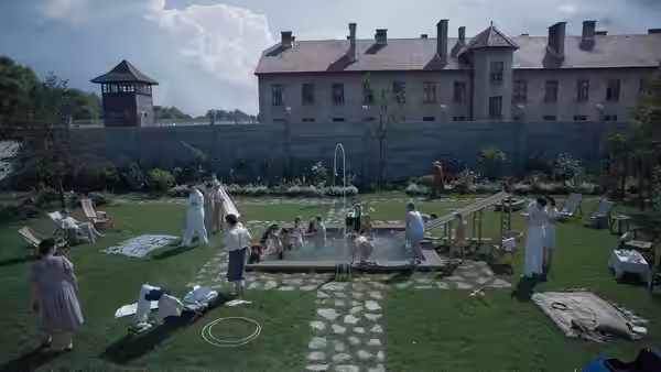 Children play in pool as family relaxes in large garden