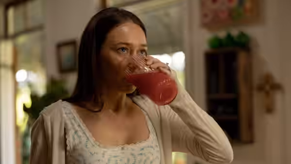 Milla Blake (Alycia Debnam-Carey) drinking red juice in home interior