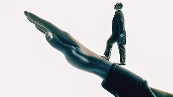 Mussolini walking across the palm of a giant outstretched hand