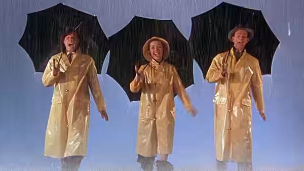 Don Lockwood (Gene Kelly), Kathy Selden (Debbie Reynolds) and Cosmo Brown (Donald O'Connor) singing in the rain