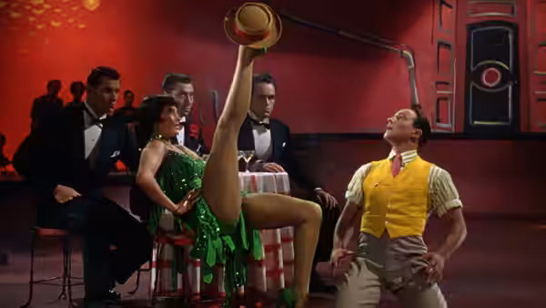 Don Lockwood (Gene Kelly) watching a dancer on a nightclub table