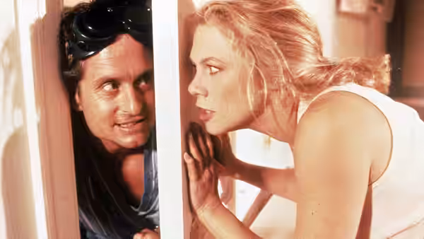 Oliver Rose (Michael Douglas) peers through a partly open door as Barbara listens