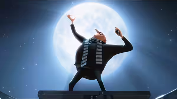 Gru (Steve Carell) raises his arms in front of a full moon