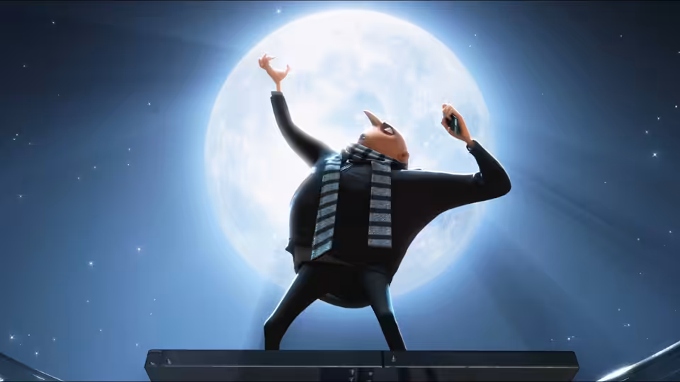 Gru (Steve Carell) raises his arms in front of a full moon