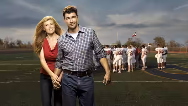 Eric Taylor and Tami Taylor hold hands on the empty football field