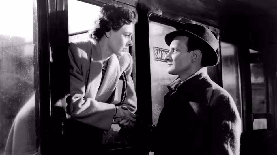 Laura Jesson (Celia Johnson) and Dr. Alec Harvey (Trevor Howard) holding hands on a train