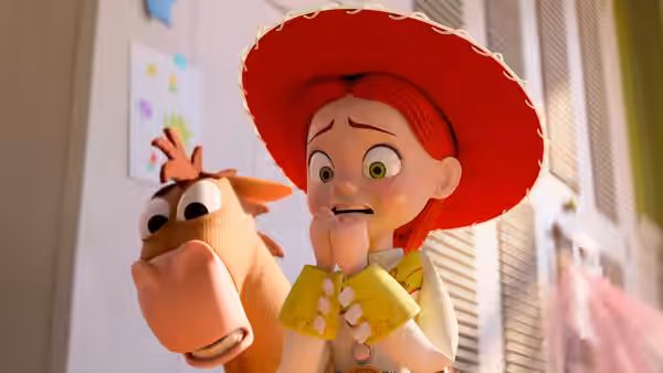 Jessie stands beside a toy horse looking concerned in a sunlit room