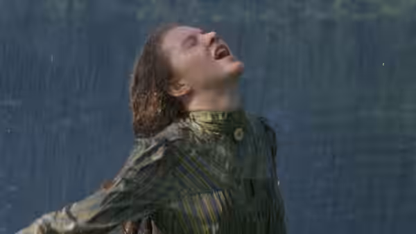 Sybylla Melvyn (Judy Davis) throws her head back in the rain