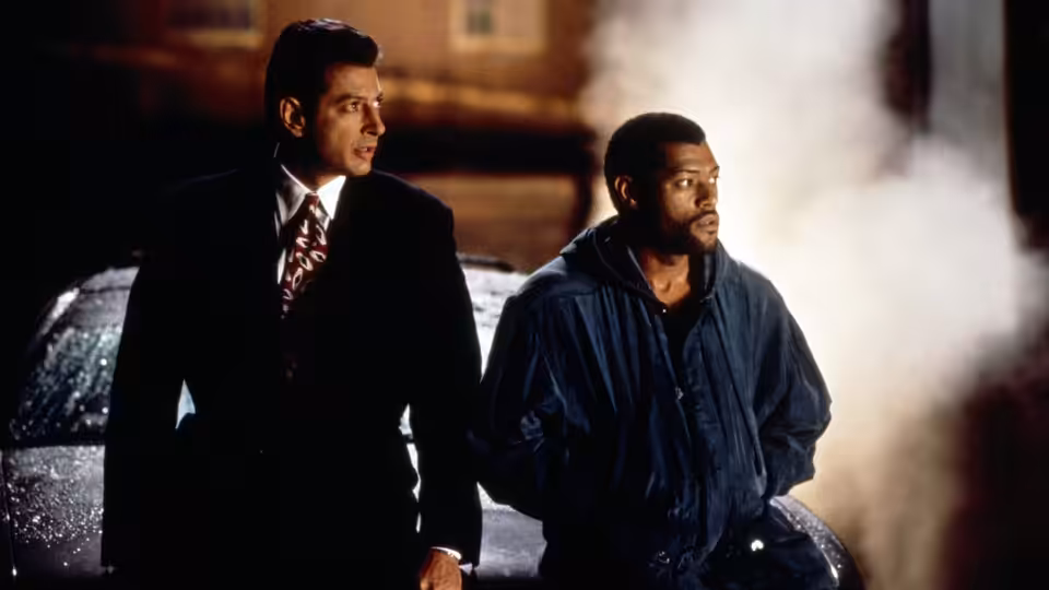 Russell Stevens Jr. (Laurence Fishburne) and David Jason (Jeff Goldblum) stand beside a car