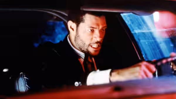 Russell Stevens Jr. (Laurence Fishburne) grips the steering wheel inside a car