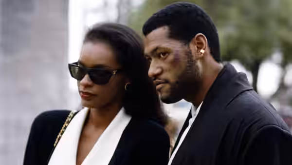 Betty McCutcheon (Victoria Dillard) walks beside Russell Stevens Jr. (Laurence Fishburne) outdoors