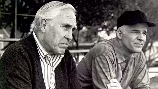 Frank Buckman (Jason Robards) and Gil Buckman (Steve Martin) sit together outdoors in a black-and-white image