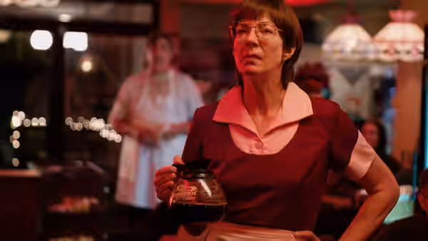 LaVona (Allison Janney) stands behind a diner counter holding a coffee pot