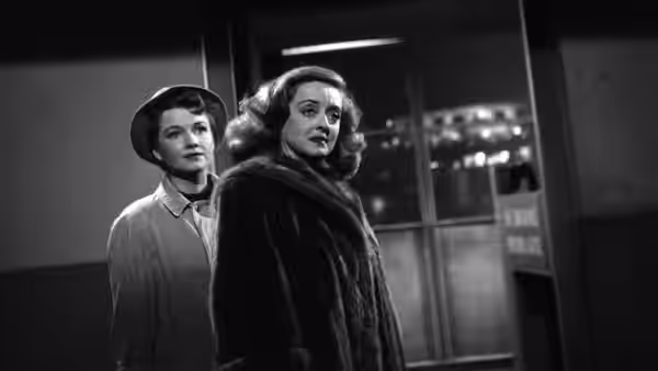 Margo Channing and Birdie Coonan standing together outside at night