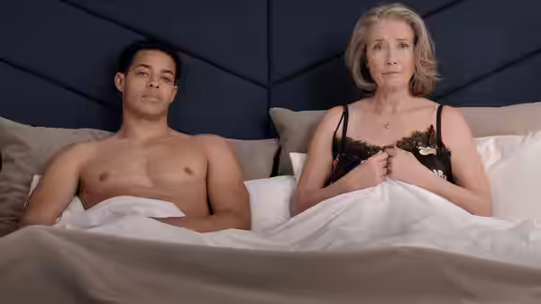 Leo Grande (Daryl McCormack) and Nancy Stokes (Emma Thompson) lie beneath covers in bed