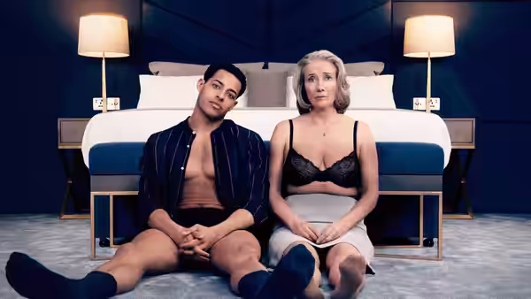 Leo Grande (Daryl McCormack) and Nancy Stokes (Emma Thompson) sit on the floor before a hotel bed