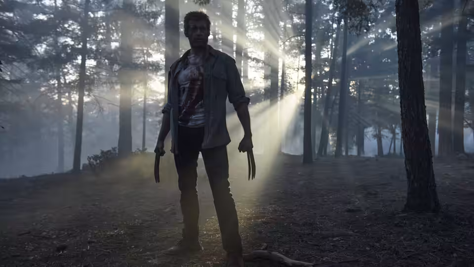 Logan (Hugh Jackman) standing among trees with claws extended