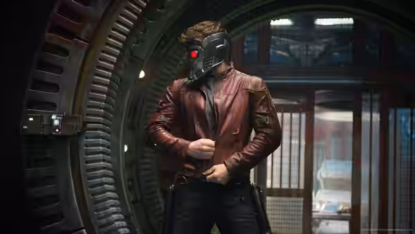 Peter Quill (Chris Pratt) in red jacket and helmet inside a circular metal doorway