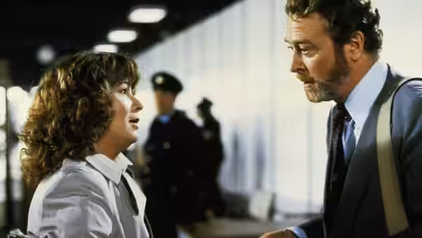 Rita (Julie Walters) facing Frank (Michael Caine) in a busy terminal corridor
