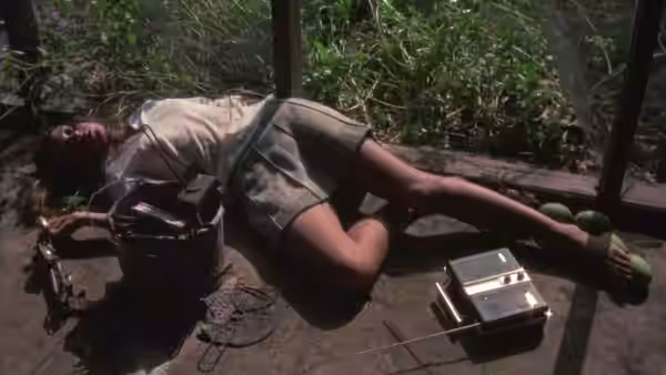 Girl (Jenny Agutter) lying on the ground next to radio equipment